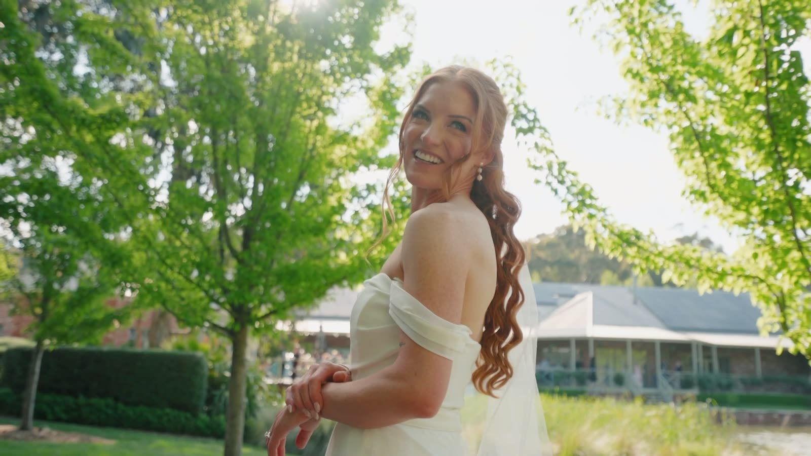 Bride smiling outdoors on her wedding day